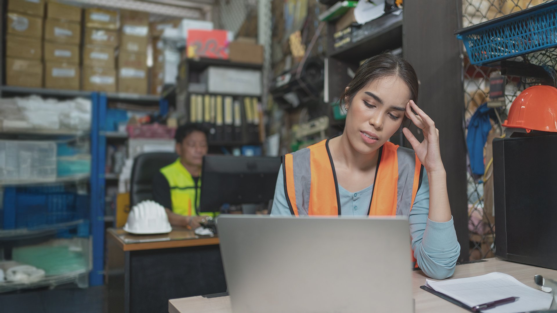 a frustrated technician looking at her laptop in dismay because she can't find the parts she is looking for